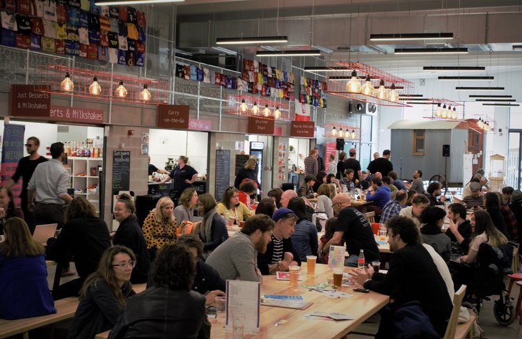 people in the indoor food court at ty pawb in wrexham