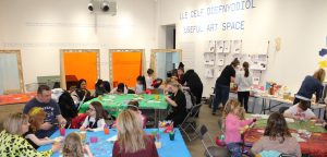 Families working on making crafts in the Useful Art Space.