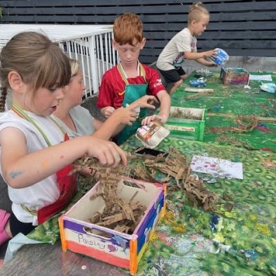 Children making bug hotels in our rooftop garden.