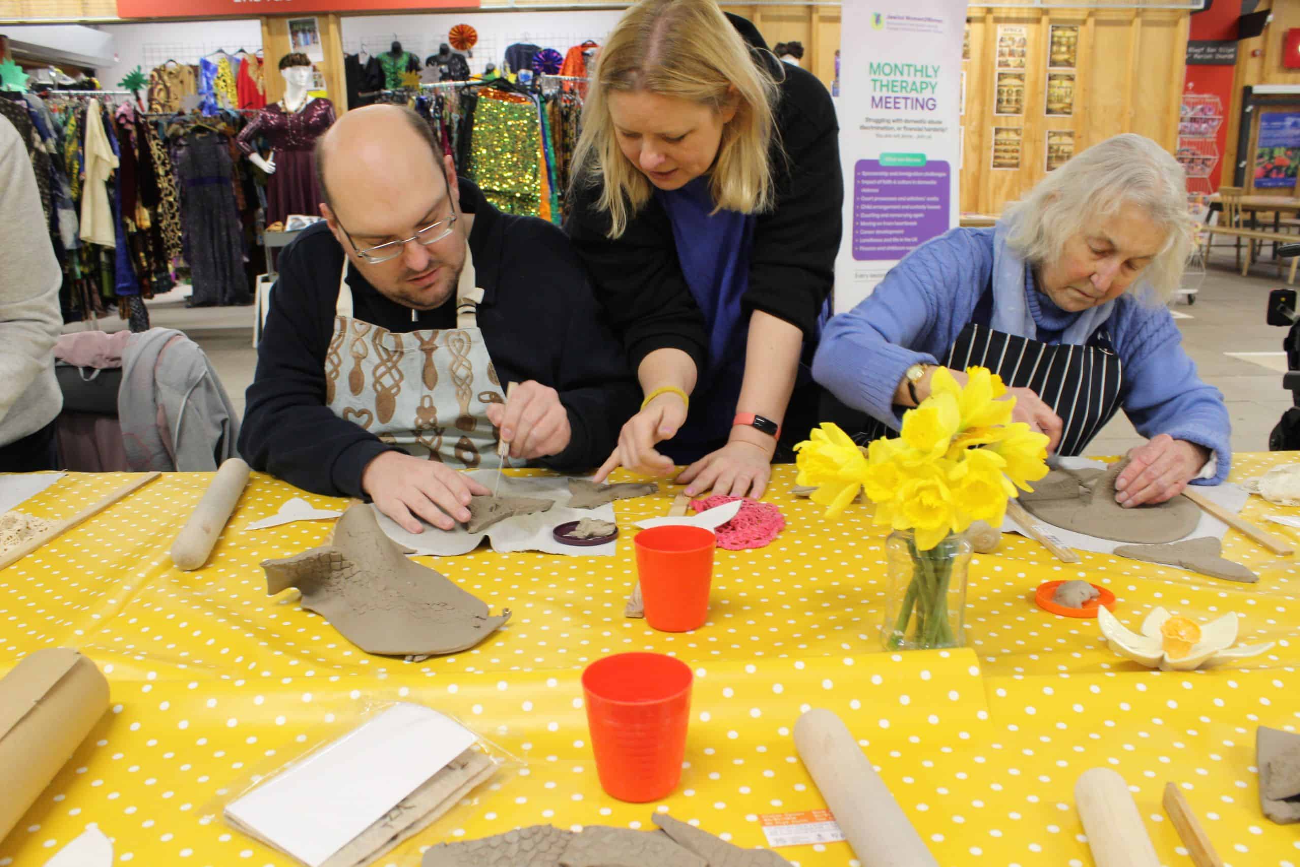 Warm Welcome attendees making clay daffodils.
