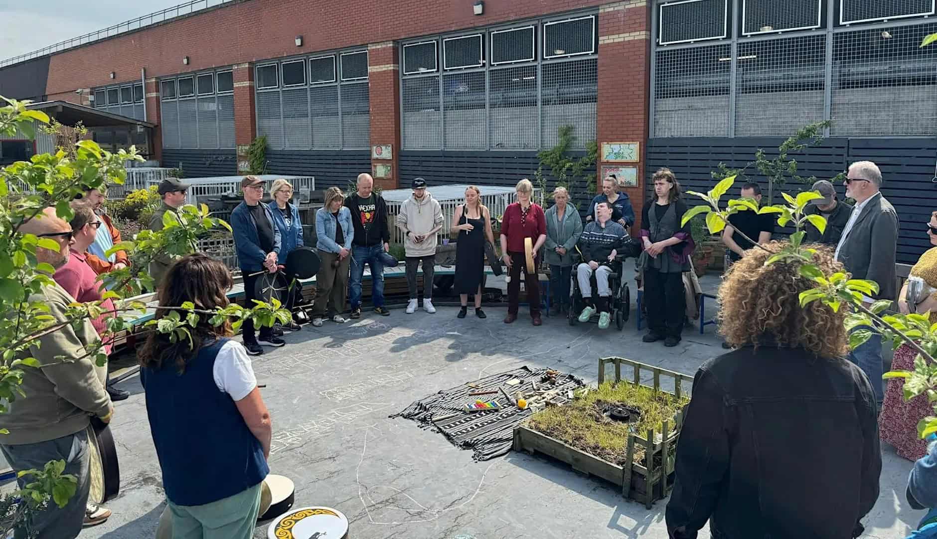 Participants gathered in a circle to take part in a drumming session in our rooftop garden.