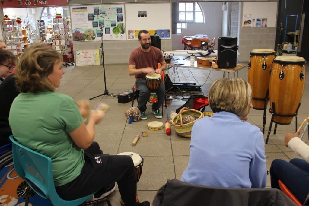 A group of mixed ability adults playing musical instruments.