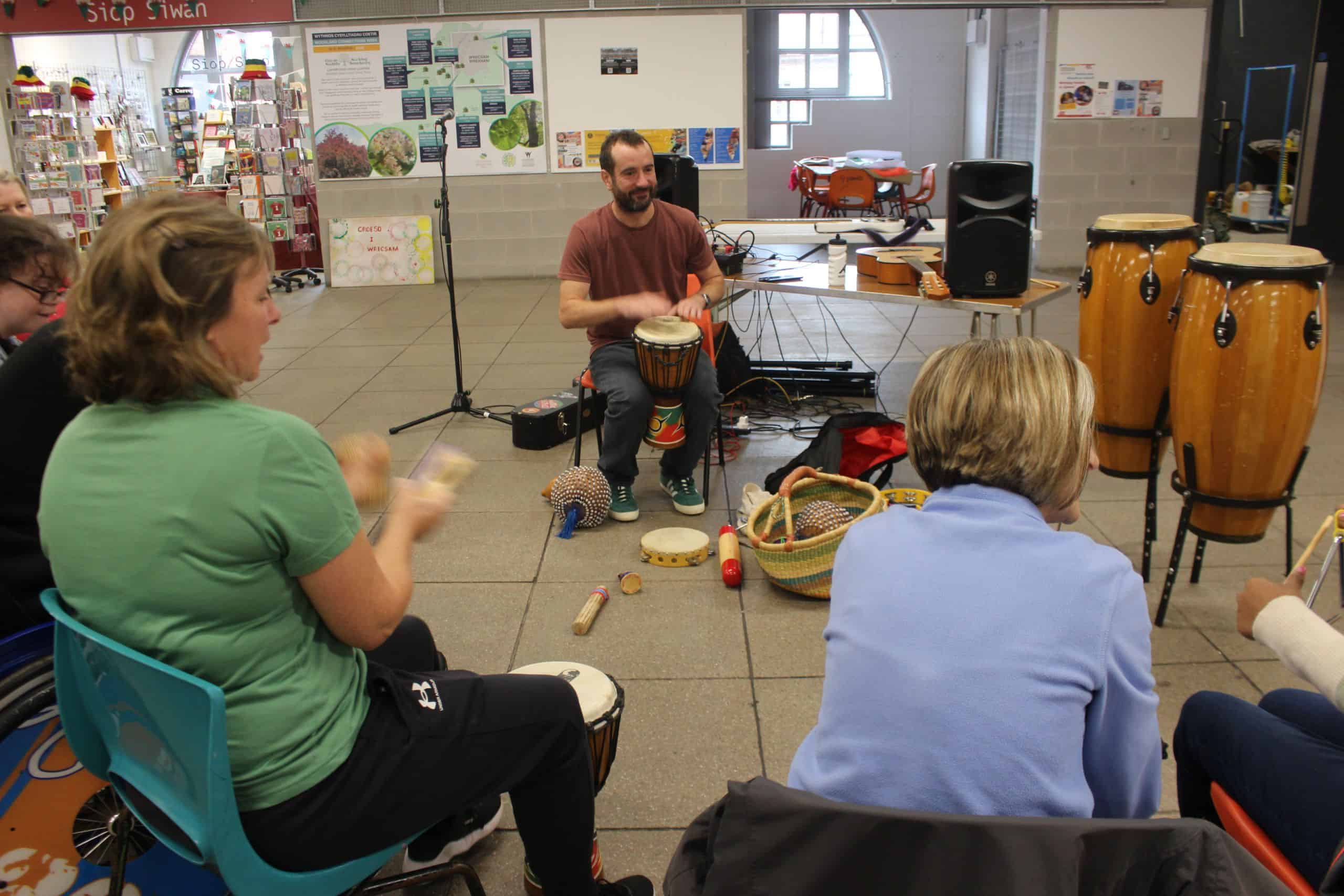 A group of mixed ability adults playing musical instruments.